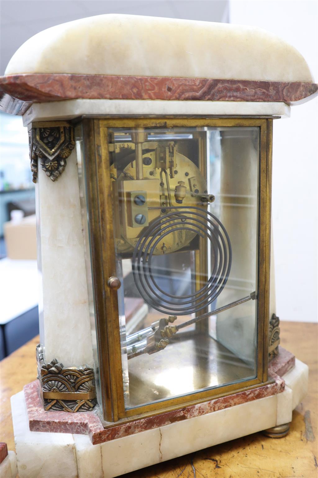 An Art Deco rouge and white marble clock garniture